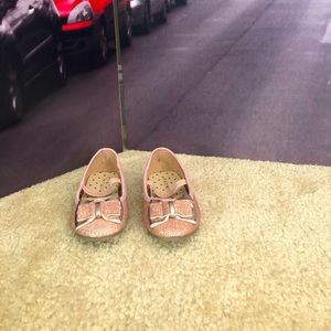 Rose gold sparkly flat shoes.